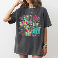 Christmas Cross T-Shirt, Be the Light Christian Shirt, Faith Inspired Holiday Tee, Bible Verse Graphic Shirt, Xmas Present for Women and Men