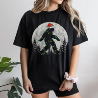 Santa Hat Sasquatch Fairy Lights Graphic Tee, Bigfoot Christmas T-Shirt, Humorous Cryptid Xmas Holiday T-Shirt, Festive Yeti Lover Top